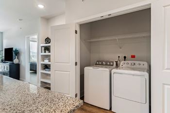A white laundry room with a washer and dryer.